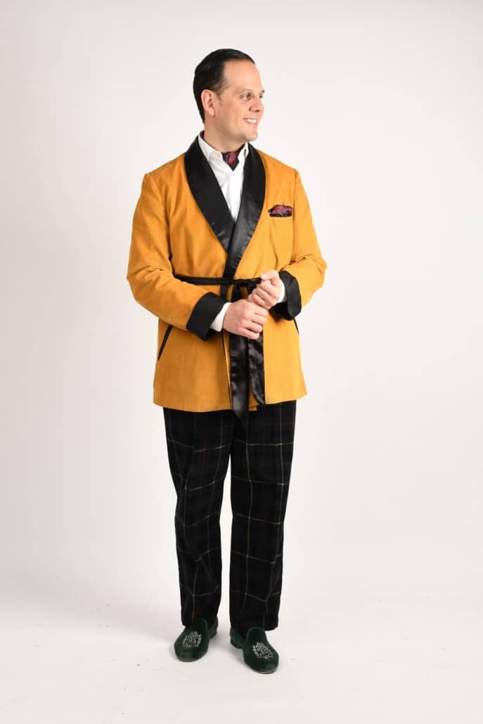 Raphael vestindo uma jaqueta de TV amarelo mostarda e calças de vidraça