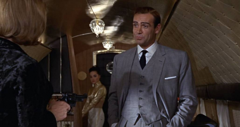 Sean Connery como James Bond em Goldfinger, vestindo um terno de lã tropical de três peças.
