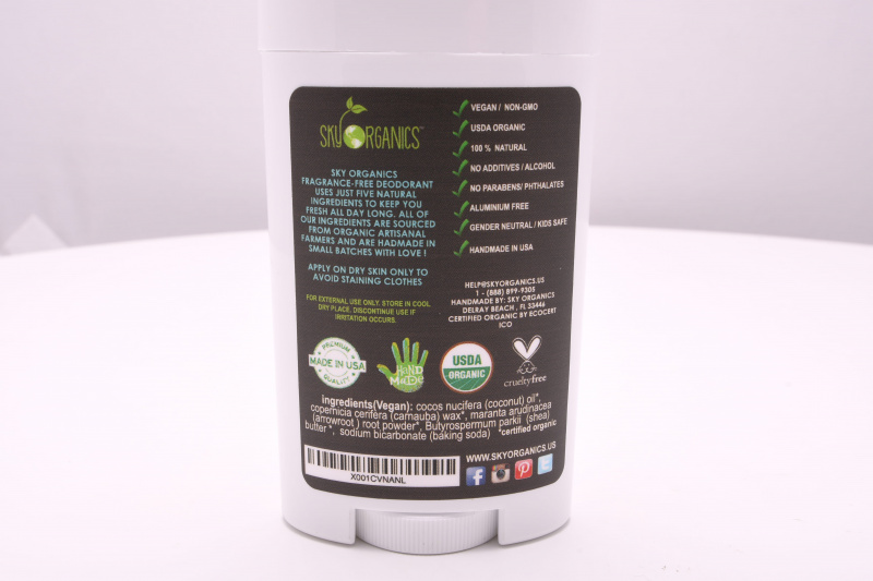Vegaani-orgaanisen deodorantin taustapuoli, jossa luetellaan sen ainesosat ja prosessit.